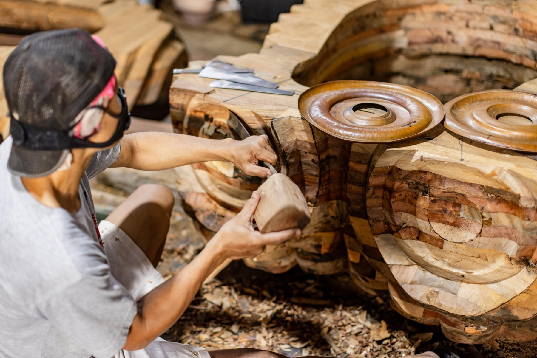 Hand-carving alongside the copper-finished eyes of the sculpture